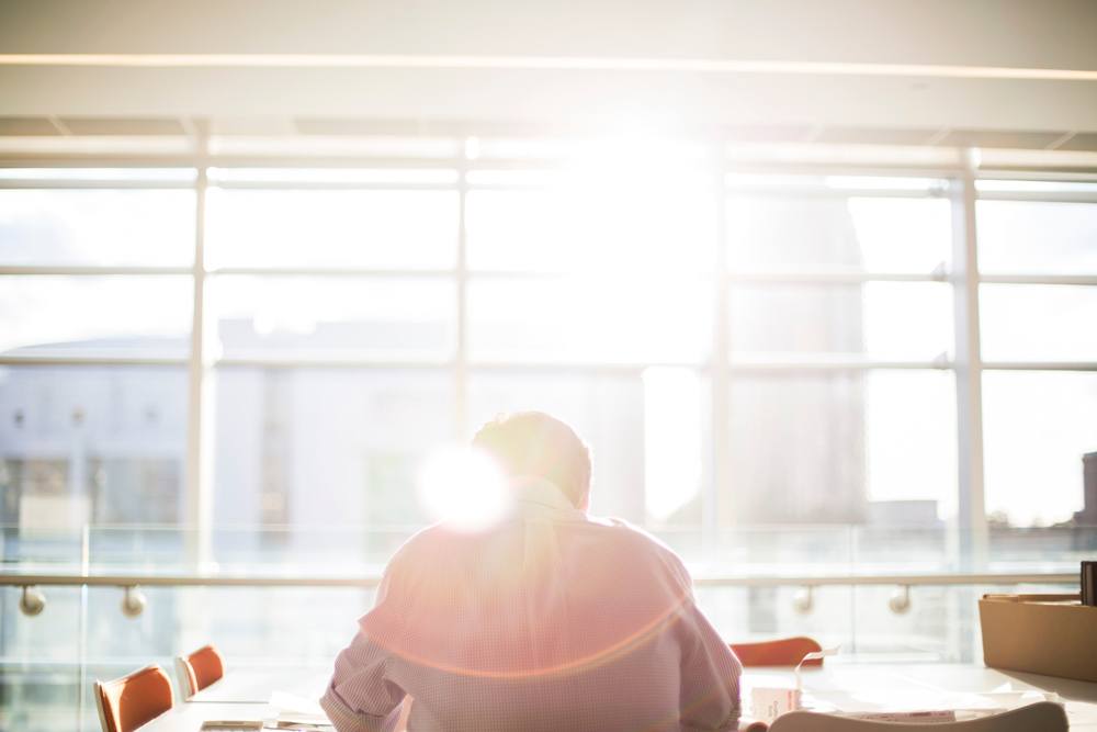 man in front of sun